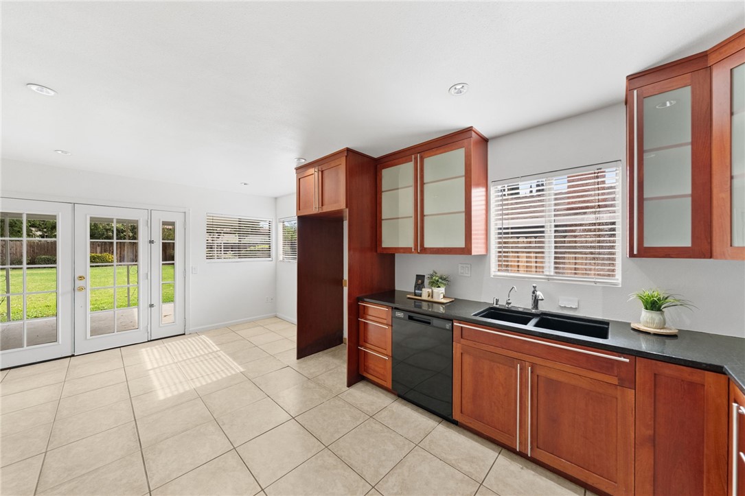 6090 Meadowbrook Lane Riverside, CA 92504 - Photo 16 of 37 Functional L-shaped layout with generous counter space, modern cabinetry, and a window over the sink.