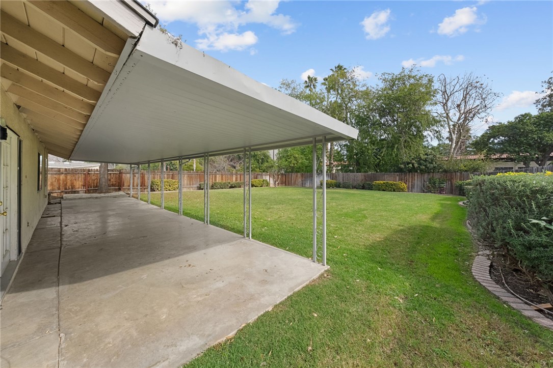 6090 Meadowbrook Lane Riverside, CA 92504 - Photo 28 of 37 Spacious covered patio overlooking a large, level lawn—ideal for outdoor dining and relaxing.