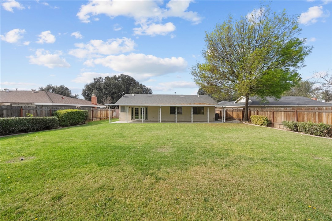 6090 Meadowbrook Lane Riverside, CA 92504 - Photo 31 of 37 Large open yard with perimeter fencing and mature landscaping, offering plenty of room for entertaining or recreation.