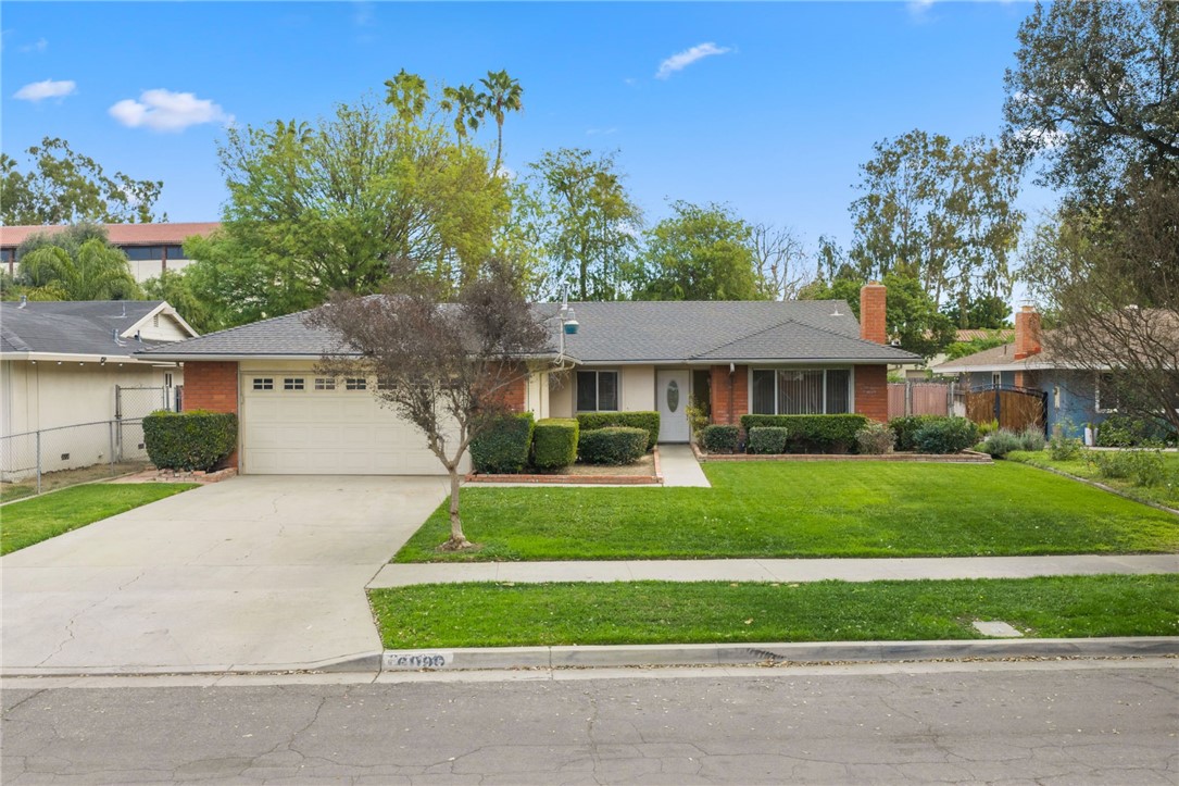 6090 Meadowbrook Lane Riverside, CA 92504 - Photo 4 of 37 Wide street presence with a deep driveway, attached garage, and manicured front yard.