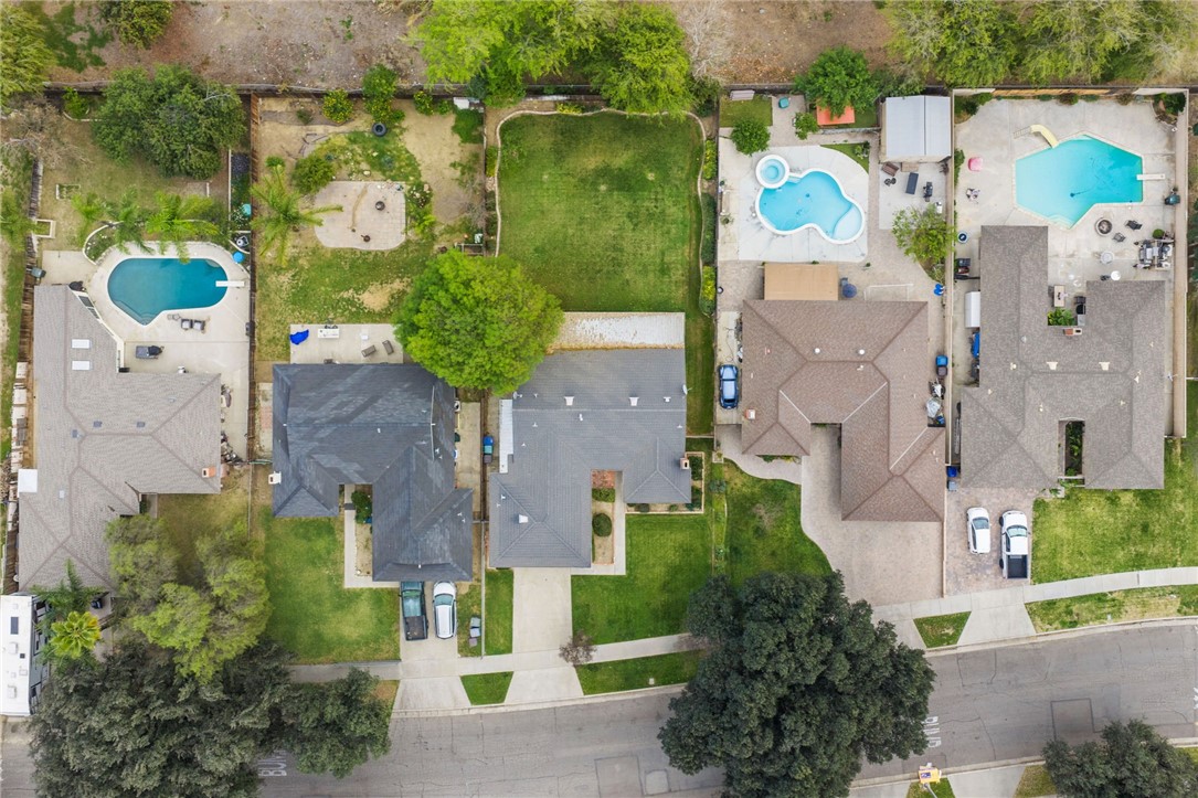 6090 Meadowbrook Lane Riverside, CA 92504 - Photo 8 of 37 Overhead perspective highlighting the home’s footprint, backyard space, and surrounding neighborhood.