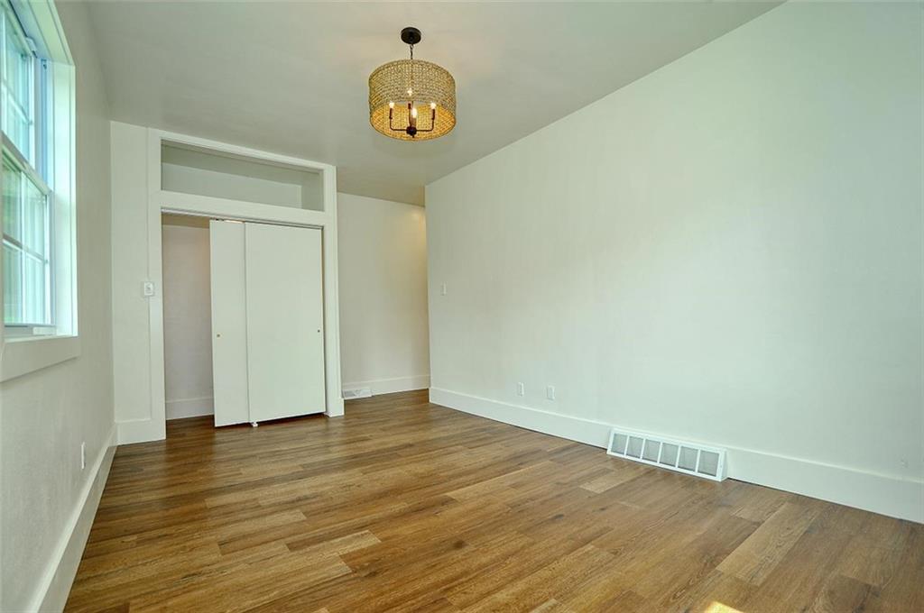 113 3rd Street Houston, PA 15342 - Photo 13 of 27 an empty room with wooden floor and window
