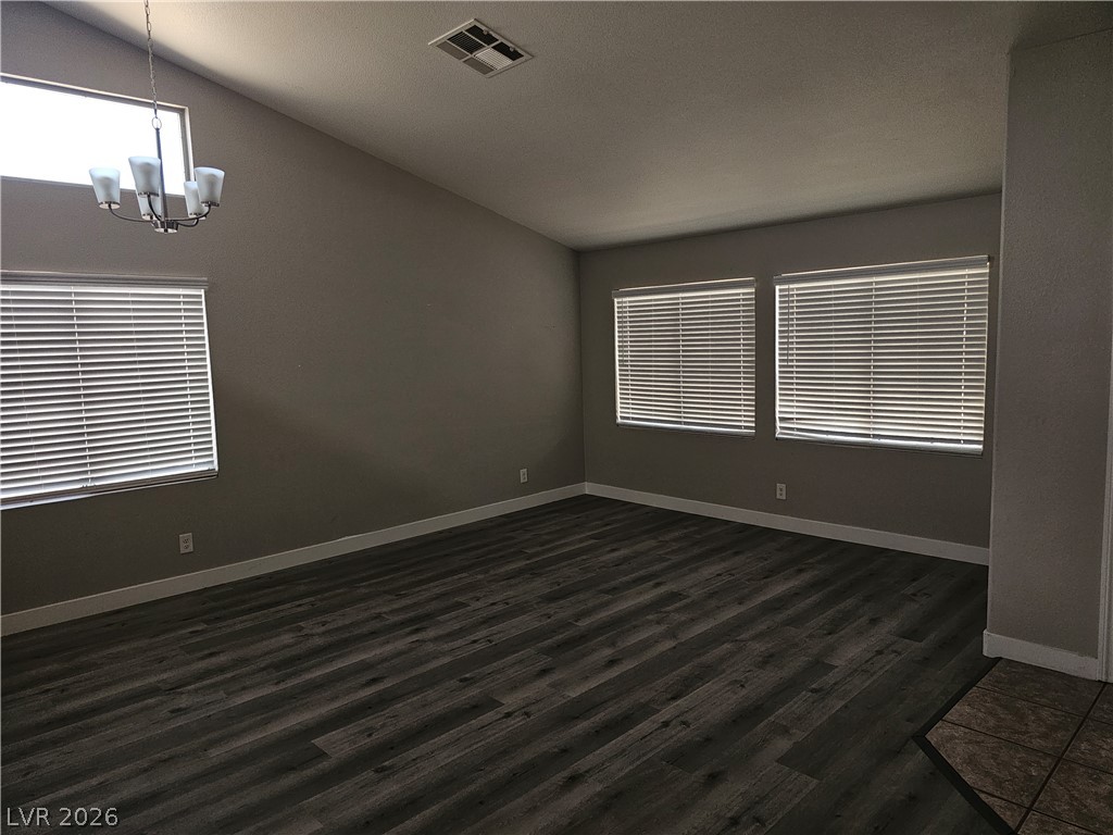 1418 Reebok Terrace Henderson, NV 89014 - Photo 21 of 38 Vast vaulted ceilings complement the durable wood-look flooring, creating an adaptable living space.