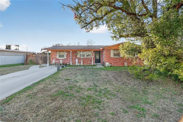front view of a house with a tree