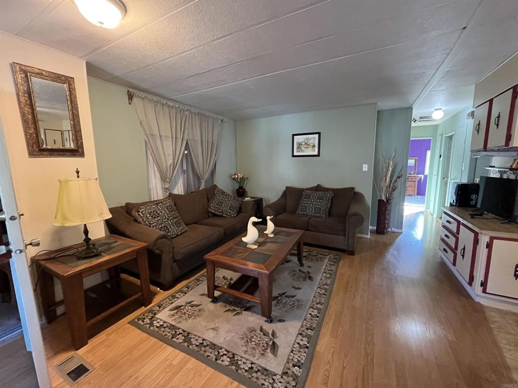1810 Hillsdale Road, Unit 99 El Cajon, CA 92019 - Photo 3 of 15 a living room with furniture a flat screen tv and a fireplace