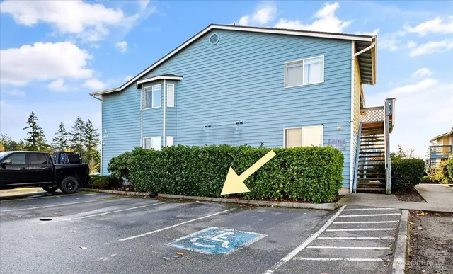 a front view of a house with a yard and potted plants
