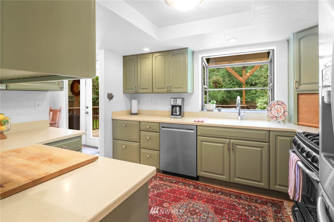 3853 Magrath Road Bellingham, WA 98226 - Photo 15 of 40 a kitchen with a stove a sink and a refrigerator