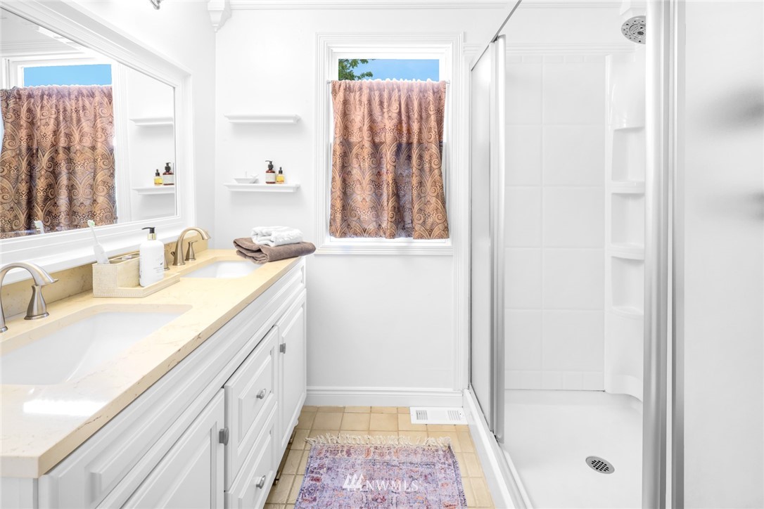 3853 Magrath Road Bellingham, WA 98226 - Photo 20 of 40 a bathroom with a sink a mirror and a shower