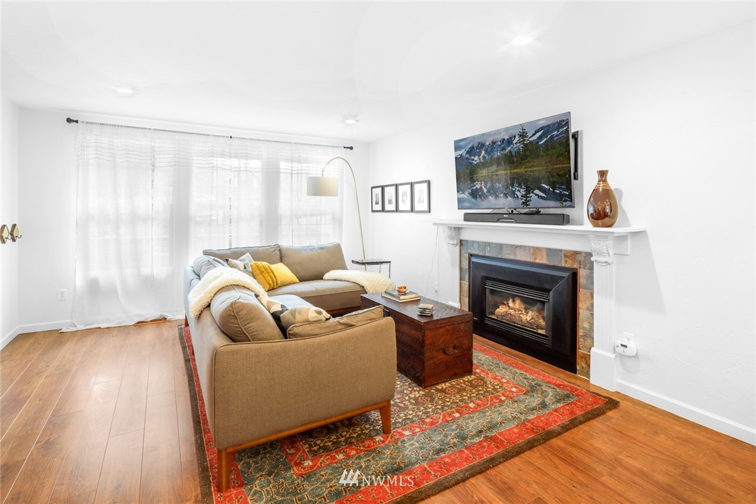 3853 Magrath Road Bellingham, WA 98226 - Photo 7 of 40 a living room with furniture a flat screen tv and a fireplace