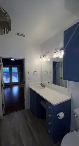 a bathroom with a sink vanity and a mirror