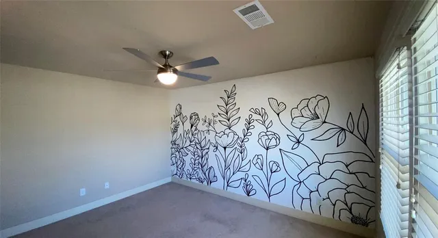 wooden floor with a white comforter and a window