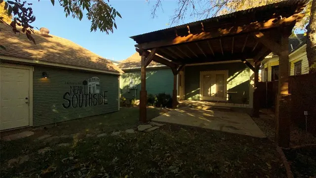 a view of porch with two chairs and a gate