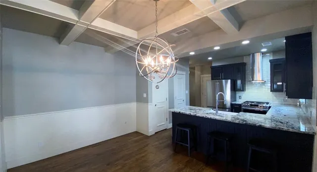 a bathroom with a sink a large mirror and vanity