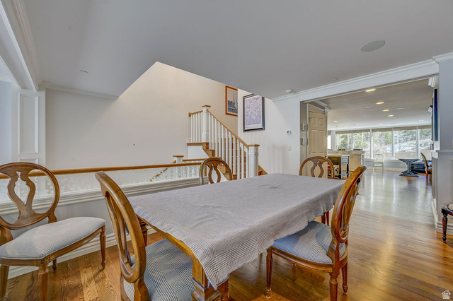 9699 Bypass Road, Unit 5 Alta, UT 84092 - Photo 20 of 54 Open-concept dining area featuring wood-finish flooring, white trim details, and a staircase with white balusters