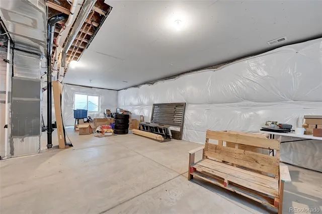 a view of a livingroom with furniture a flat screen tv and fireplace