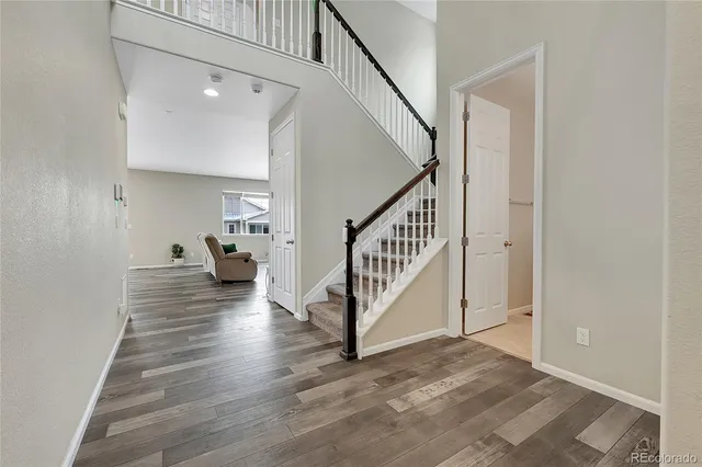 a view of entryway and hall with wooden floor
