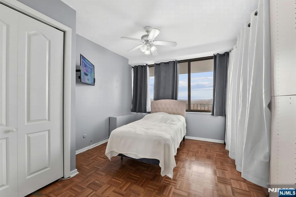 277 Prospect Avenue, Unit 11H Hackensack, NJ 07601 - Photo 15 of 23 a living room with furniture and a chandelier