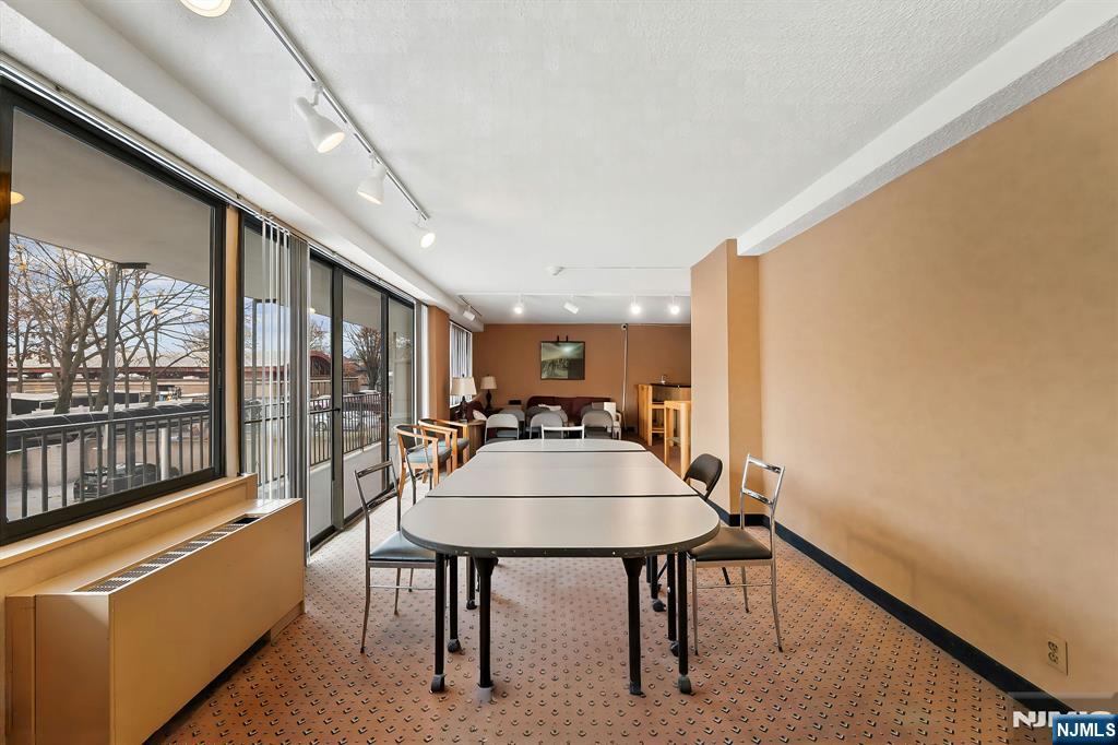 277 Prospect Avenue, Unit 11H Hackensack, NJ 07601 - Photo 18 of 23 a view of a dining room with furniture window and outside view
