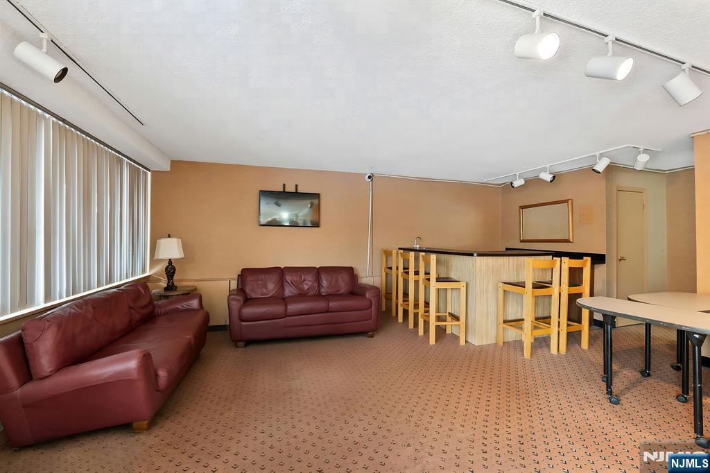 277 Prospect Avenue, Unit 11H Hackensack, NJ 07601 - Photo 19 of 23 a living room with furniture