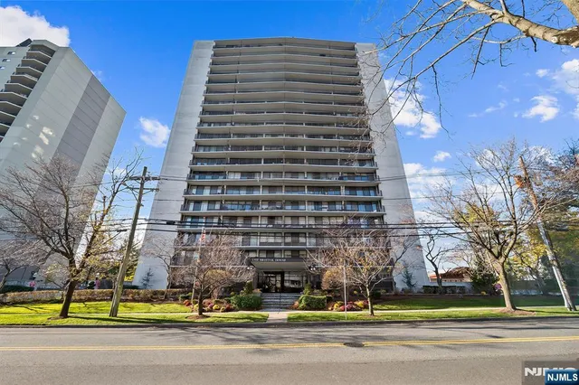 a view of a tall building next to a road