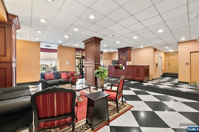 a living room with furniture a rug and a chandelier