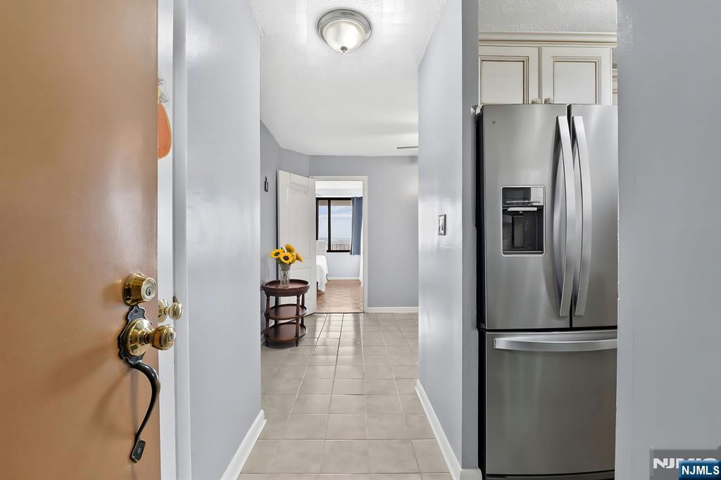 277 Prospect Avenue, Unit 11H Hackensack, NJ 07601 - Photo 7 of 23 a view of a kitchen from the hallway