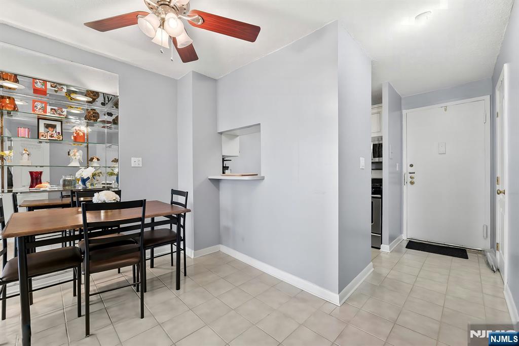 277 Prospect Avenue, Unit 11H Hackensack, NJ 07601 - Photo 8 of 23 a view of a livingroom with furniture and chandelier fan