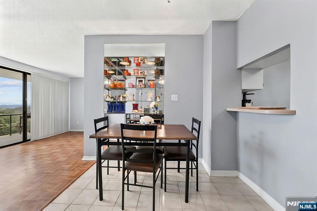 277 Prospect Avenue, Unit 11H Hackensack, NJ 07601 - Photo 9 of 23 a view of a dining room with furniture and wooden floor