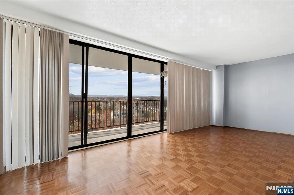 277 Prospect Avenue, Unit 11H Hackensack, NJ 07601 - Photo 10 of 23 wooden floor in an empty room with a window