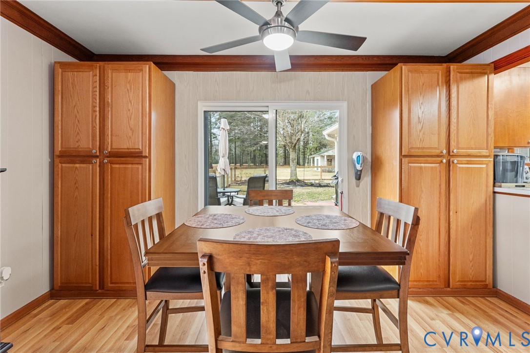 8674 Mary Ball Road Lancaster, VA 22503 - Photo 16 of 38 a dining room with furniture a chandelier and wooden floor