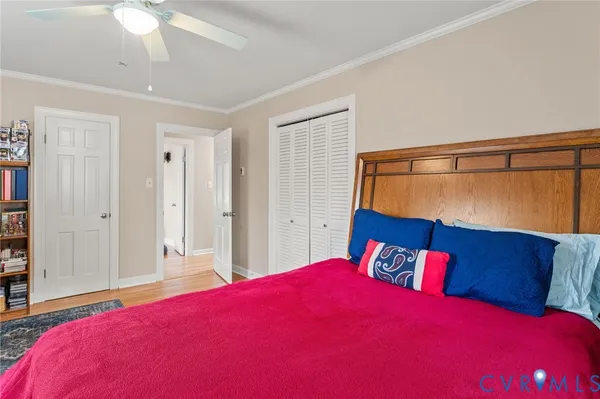a bedroom with a large bed and a mirror