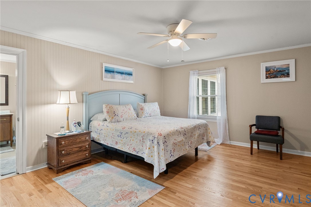 8674 Mary Ball Road Lancaster, VA 22503 - Photo 29 of 38 a bedroom with a bed and a chair with the wooden floor