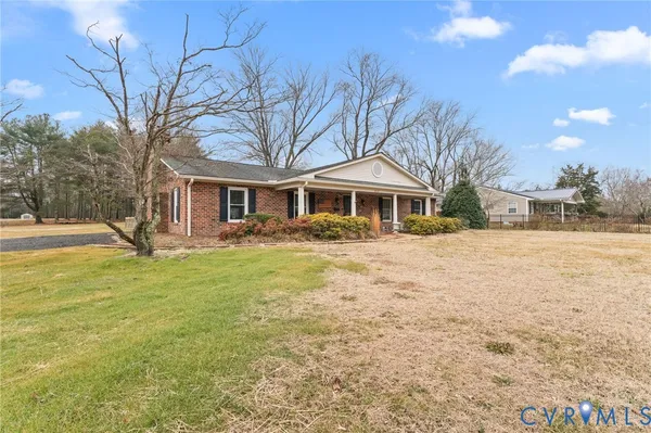 a front view of a building with a garden