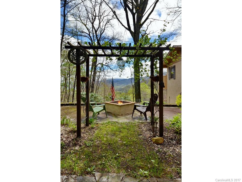 338 The High Road Waynesville, NC 28786 - Photo 2 of 19 a view of a chairs and table in the patio