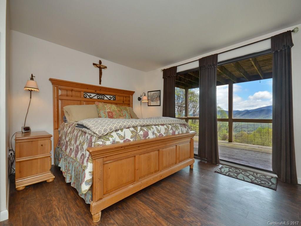 338 The High Road Waynesville, NC 28786 - Photo 14 of 19 a bed sitting in a bedroom next to a window