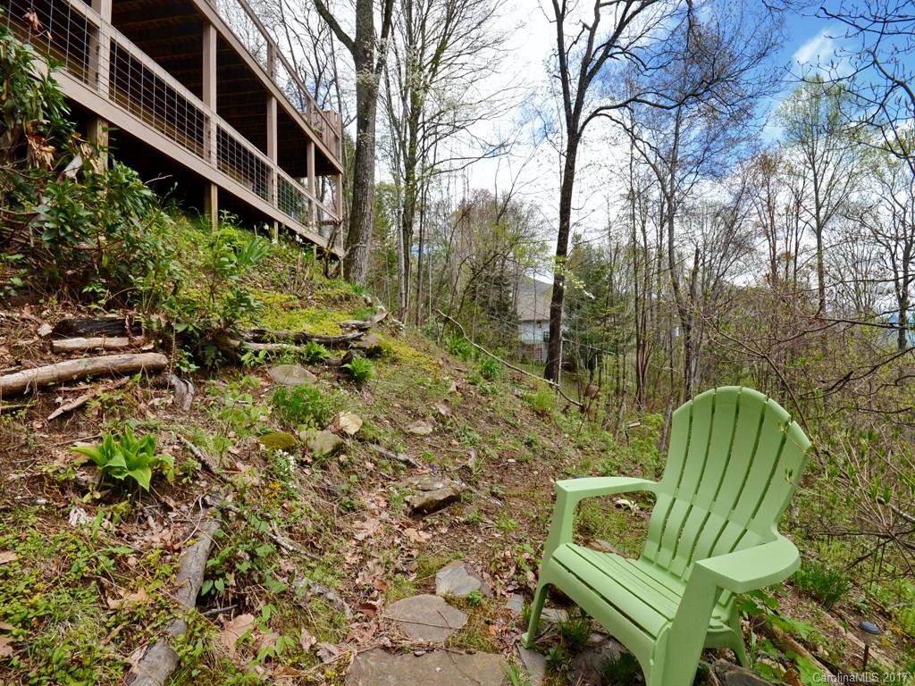 338 The High Road Waynesville, NC 28786 - Photo 17 of 19 a view of a chairs in a backyard