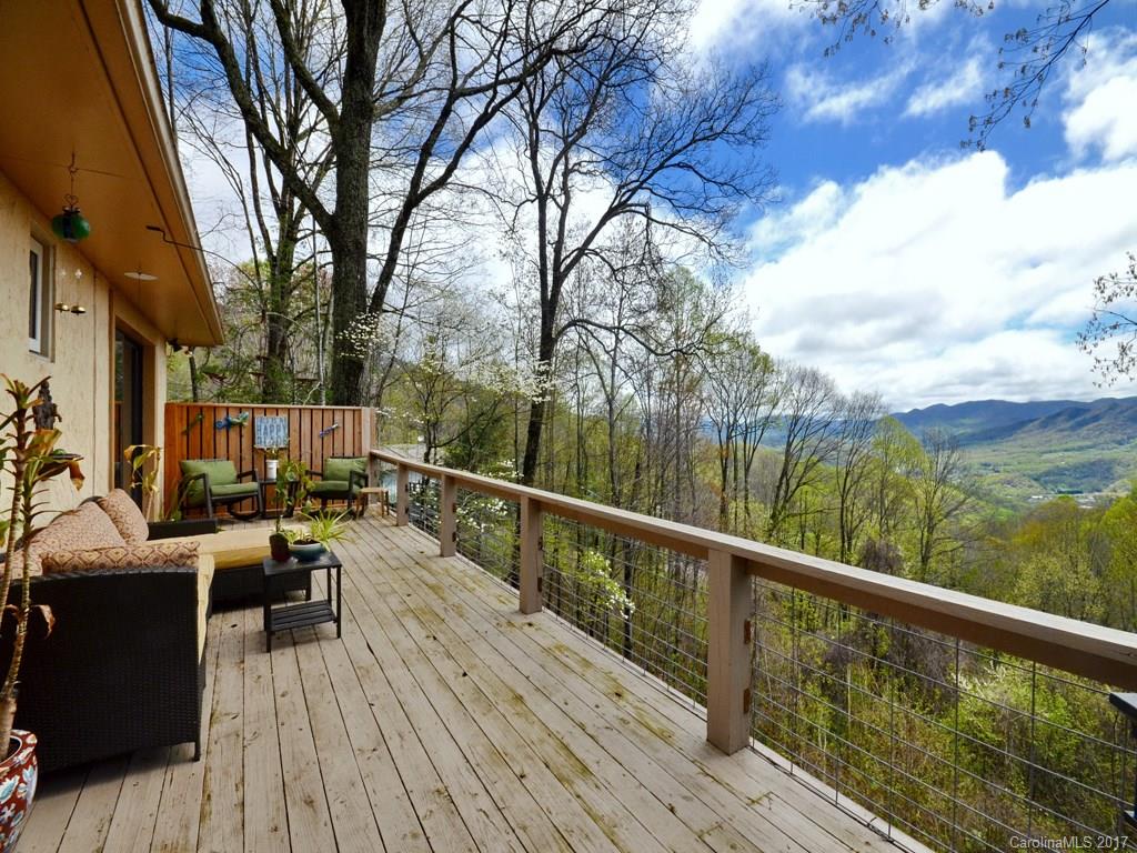 338 The High Road Waynesville, NC 28786 - Photo 3 of 19 a view of balcony with chairs and wooden fence