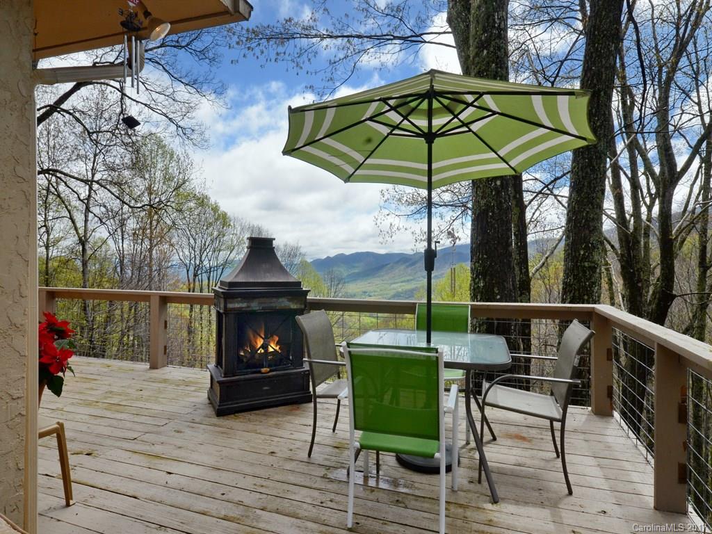 338 The High Road Waynesville, NC 28786 - Photo 4 of 19 a view of a chairs and table under an umbrella in backyard