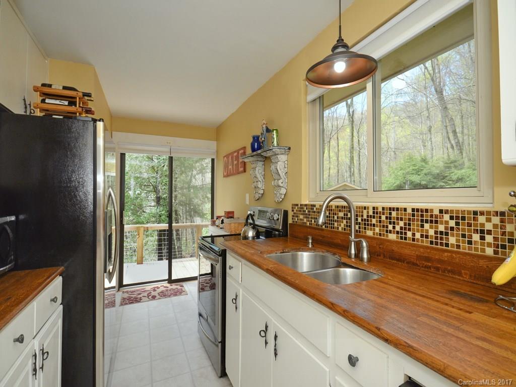 338 The High Road Waynesville, NC 28786 - Photo 10 of 19 a kitchen with a sink and a large window