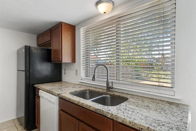 a kitchen with a sink cabinets and refrigerator