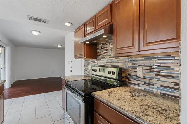 a kitchen with a stove and a sink
