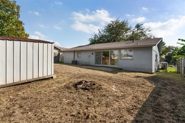 a backyard of a house with wooden floor and fence
