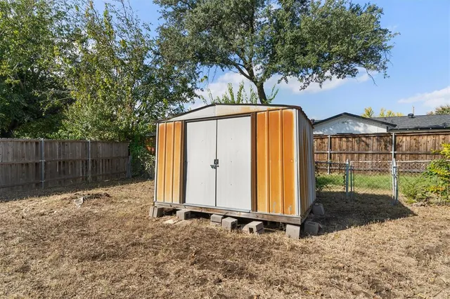a backyard of a house with table and chairs