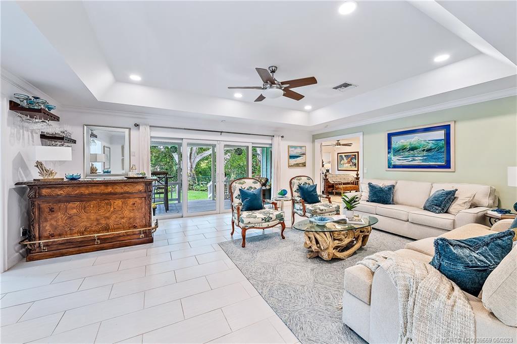 48 North River Road Stuart, FL 34996 - Photo 10 of 43 Large Living Room overlooking the back porch and all the Orchids, plants and Florida flora handcrafted by owner