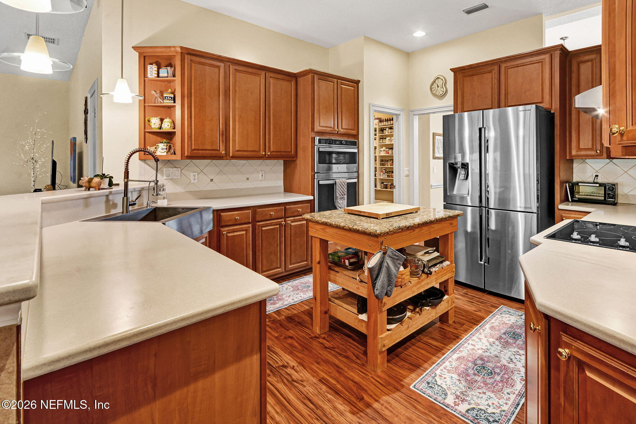 5950 West Shores Road Orange Park, FL 32003 - Photo 4 of 42 a kitchen with stainless steel appliances granite countertop a refrigerator a stove and a sink with wooden cabinets