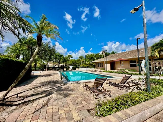 a view of a patio with a table chairs and a backyard