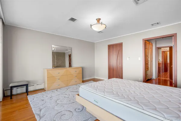 a bedroom with a bed and a chandelier