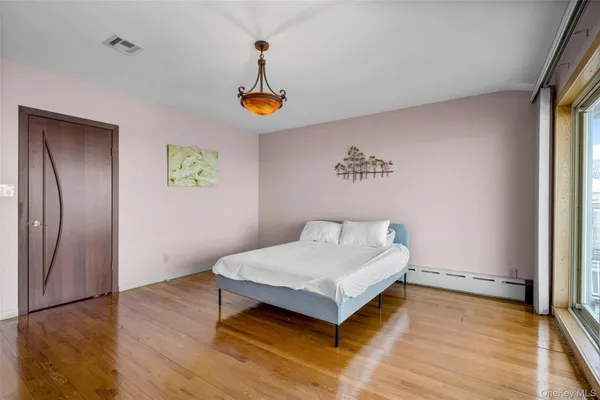 a view of a balcony with chairs and wooden floor