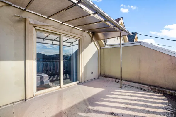 a view of a balcony with wooden floor