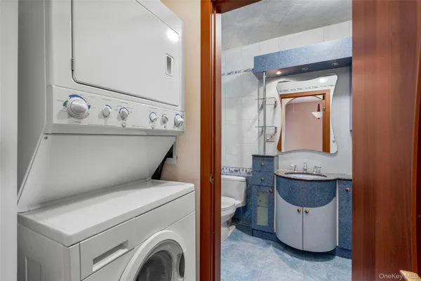 a bathroom with a granite countertop shower sink vanity and mirror